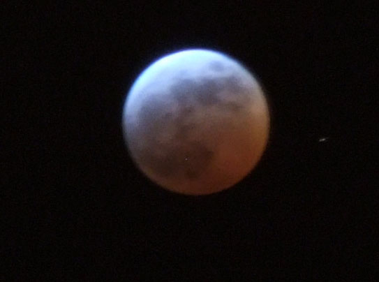 The eclipse gave the moon an orangey hue.
